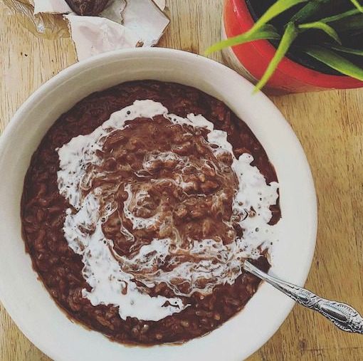 Filipino champorado with evaporated milk on top.