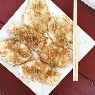 Filipino delicacy on a square dish with chopsticks.