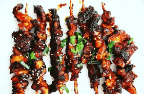 Skewered Filipino dish garnished with scallions.